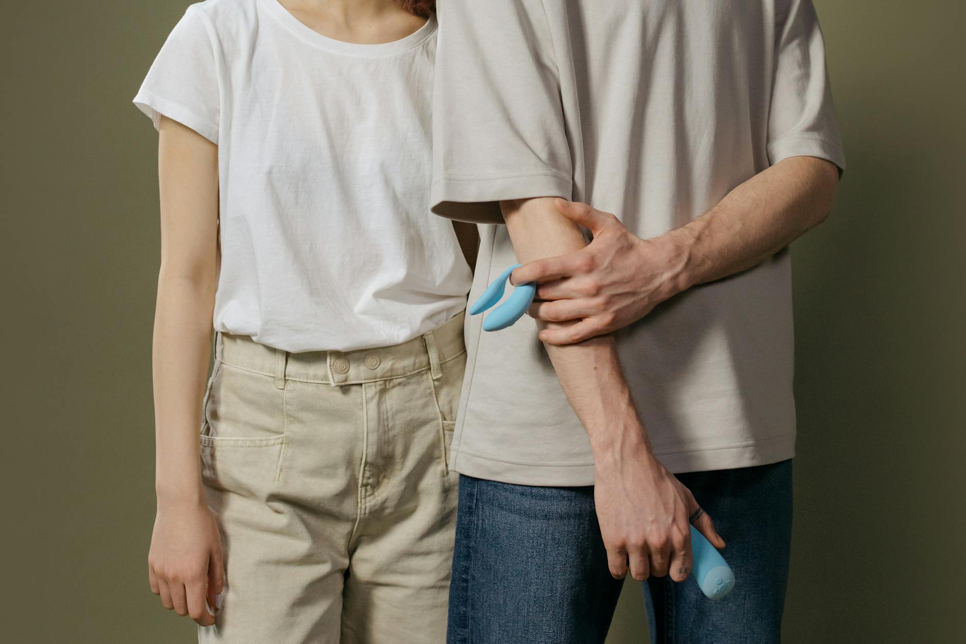 A couple exploring pleasure together with a modern vibrator, representing safe intimacy with hormonal contraception.